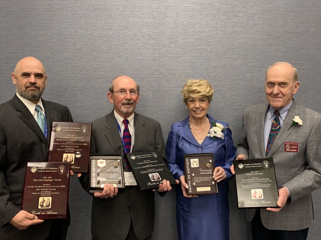 Pictured above from the left, Deputy Grand Knight Rich Rivera holds the "Just Ask" and "CPID" awards; Grand Knight Ed Doyle has the "Large Council of the Year" and "Faith" awards; Mary Anne Honzik displays the "Community" award plaque and her husband Bob holds the "Family of the Year" award won by the Honziks.
